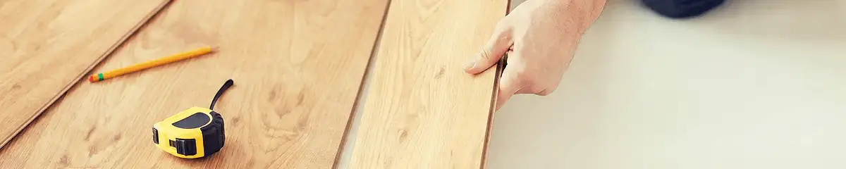 A professional installing wood flooring in Miami, FL