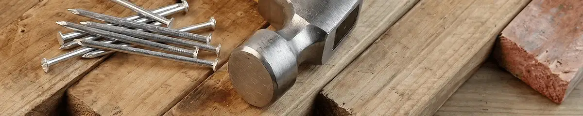 Hammer and nails on hardwood flooring boards in Miami, FL