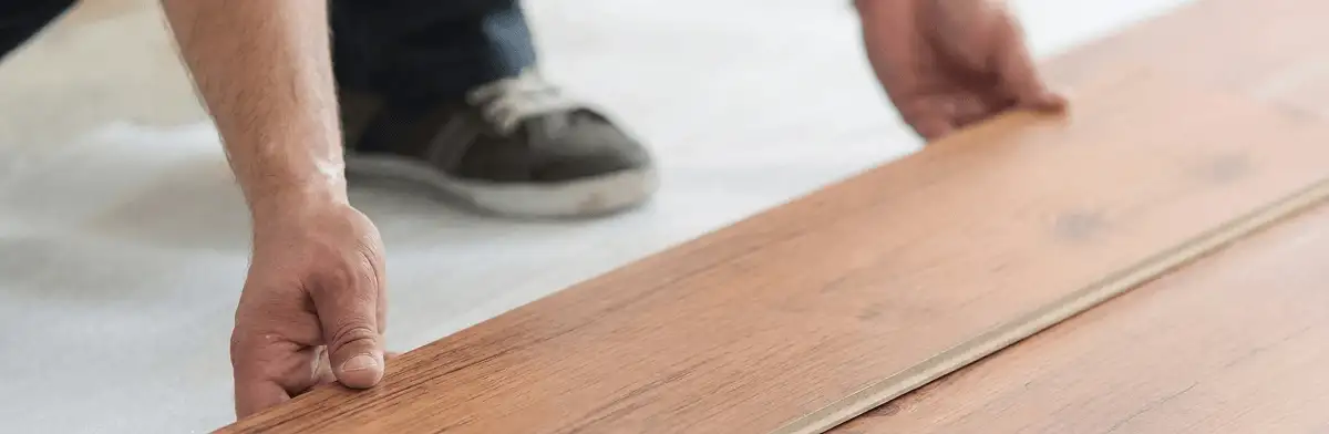 A professional installing laminate flooring in Miami, FL