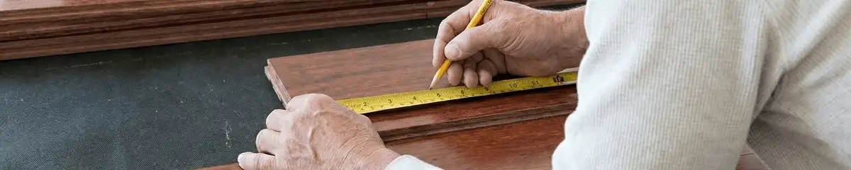 A professional installing wood flooring in Miami, FL